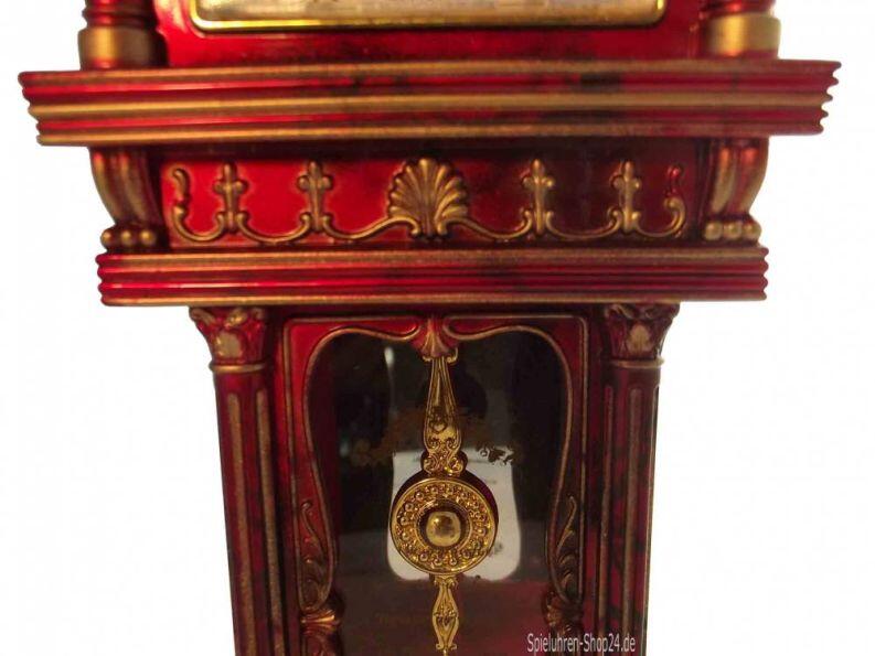 Standuhr mit Uhr und Spieluhr, Ansicht II Mittelteil und Übergang Kopf vorn mit Pendel hinter